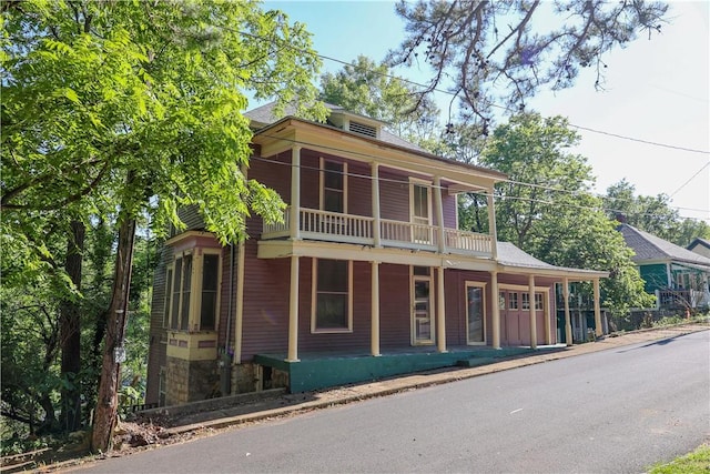 view of front of property featuring a balcony and covered porch