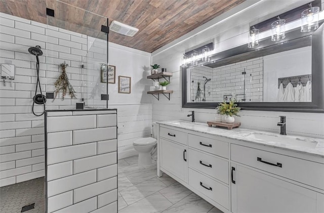 bathroom with toilet, wooden walls, wooden ceiling, tiled shower, and vanity