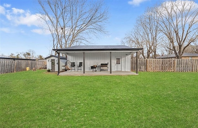 exterior space with a storage shed, a patio area, and a yard