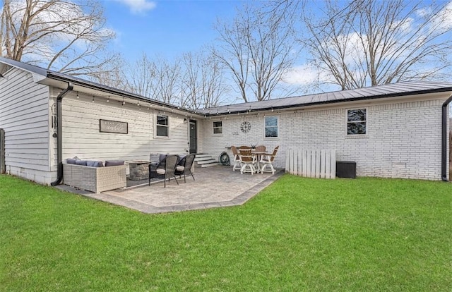 back of house with an outdoor hangout area, a yard, and a patio