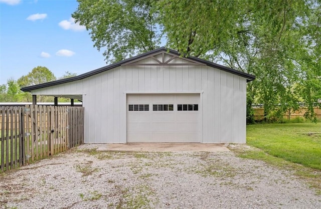 garage with a detached garage and fence