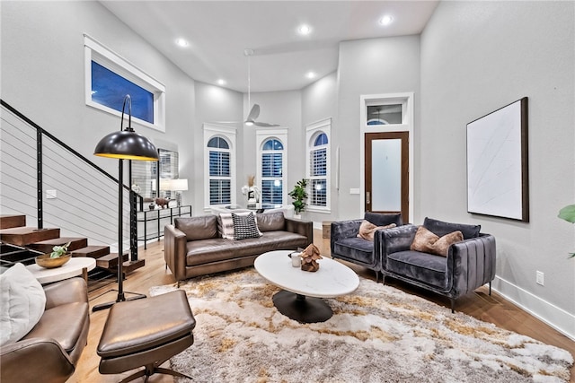 living room featuring wood-type flooring and a high ceiling