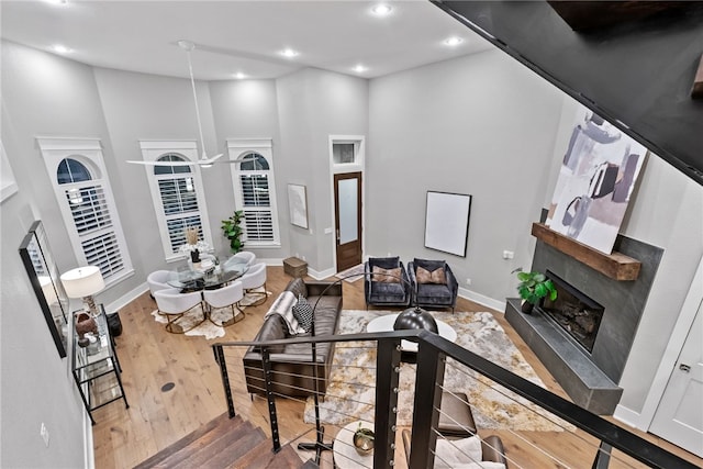 living room with a towering ceiling and hardwood / wood-style flooring