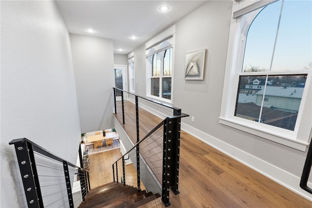 stairs with hardwood / wood-style floors