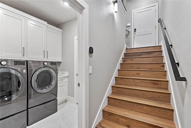 laundry area with cabinets and separate washer and dryer