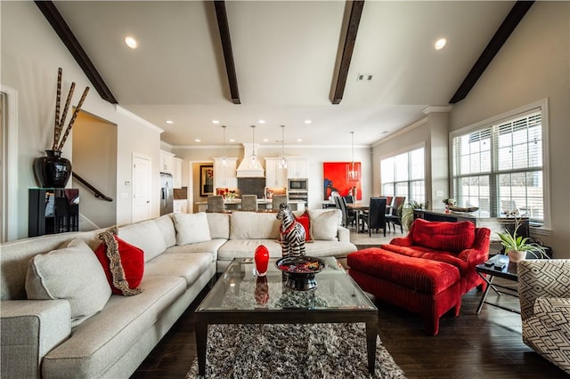 living room featuring dark hardwood / wood-style floors, ornamental molding, and vaulted ceiling with beams