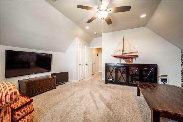 interior space with vaulted ceiling, ceiling fan, and light colored carpet