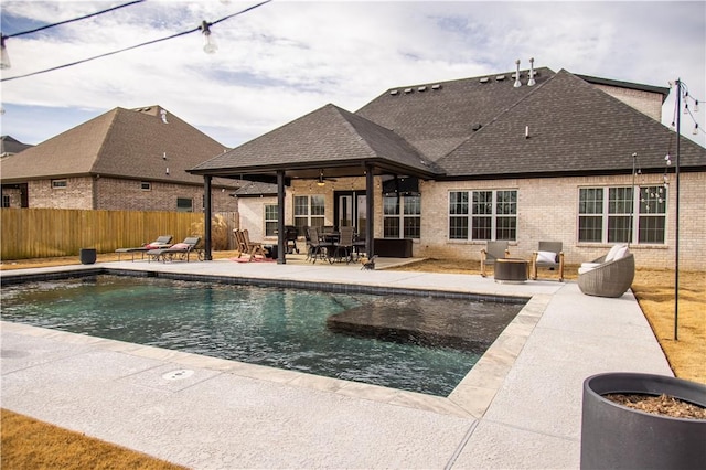 view of swimming pool featuring ceiling fan and a patio