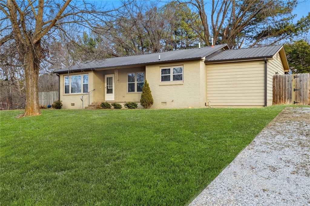 ranch-style house with a front lawn