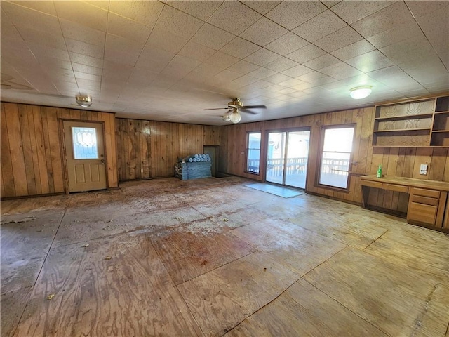 unfurnished living room with ceiling fan