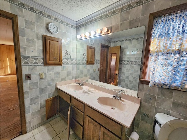 bathroom with tile walls, ornamental molding, and a textured ceiling