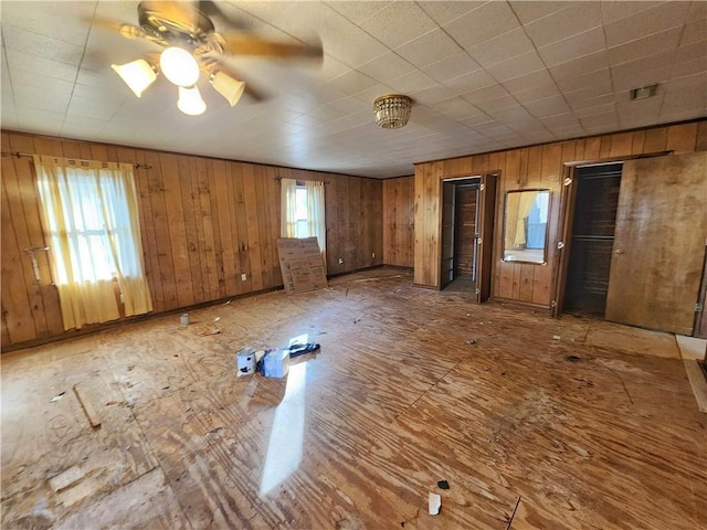 interior space with ceiling fan