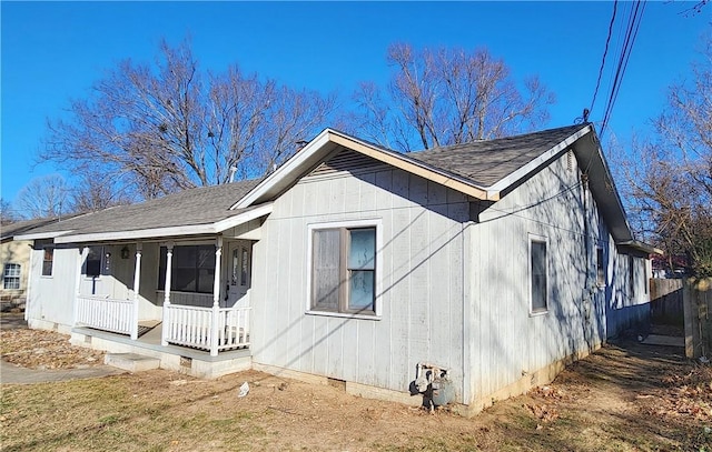 view of side of property featuring covered porch