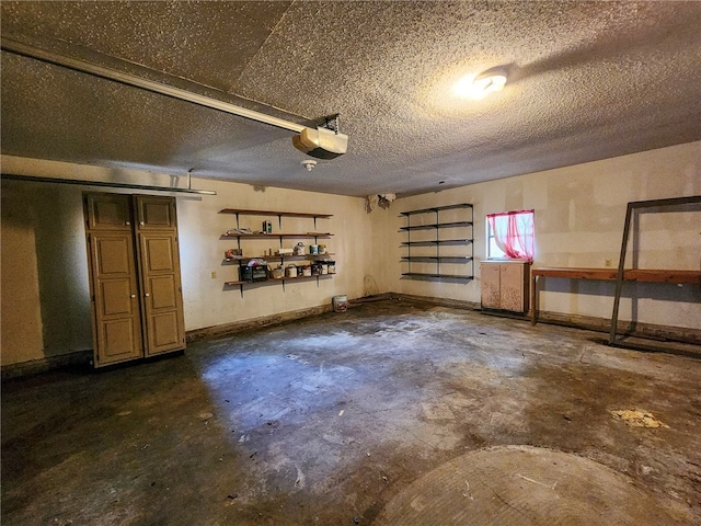basement featuring a textured ceiling and a garage