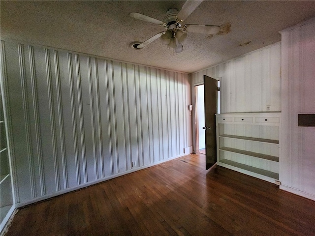 spare room featuring wood finished floors, a textured ceiling, and a ceiling fan