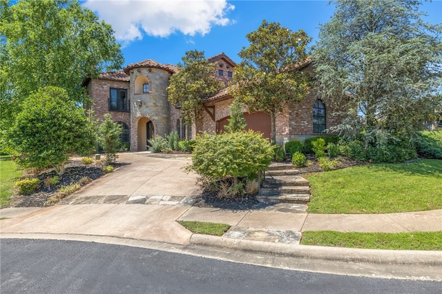 mediterranean / spanish-style home with a front yard