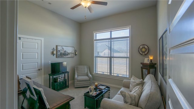 carpeted living room featuring ceiling fan