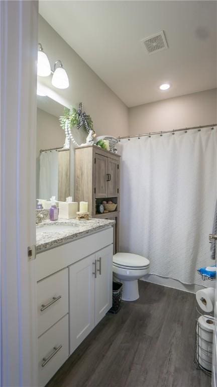 bathroom featuring hardwood / wood-style flooring, vanity, and toilet