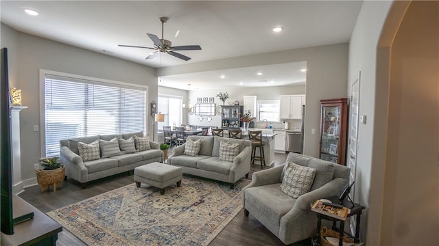 living room with dark wood-type flooring and ceiling fan