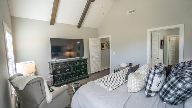 bedroom featuring beamed ceiling, dark hardwood / wood-style flooring, and high vaulted ceiling