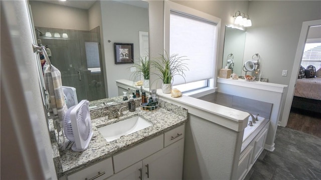 bathroom featuring vanity and separate shower and tub