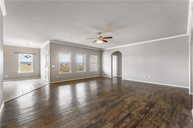 unfurnished living room featuring dark wood-type flooring, ceiling fan with notable chandelier, and ornamental molding