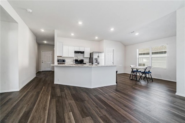 kitchen featuring stainless steel appliances, an island with sink, white cabinets, and dark hardwood / wood-style flooring