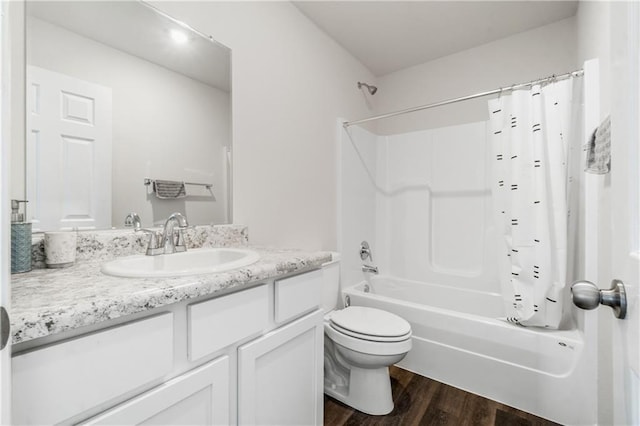 full bathroom with shower / bath combo with shower curtain, hardwood / wood-style flooring, vanity, and toilet