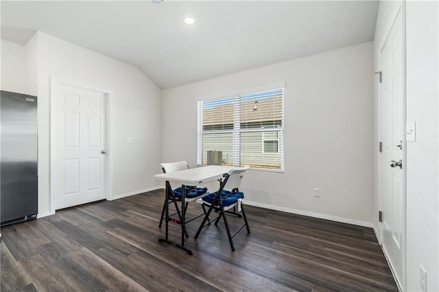 dining space with vaulted ceiling and dark hardwood / wood-style floors