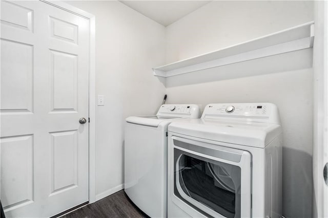 washroom with dark hardwood / wood-style flooring and separate washer and dryer