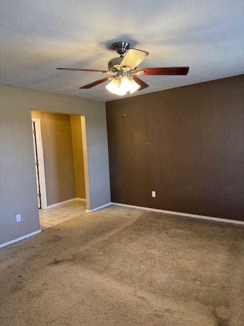 unfurnished room featuring ceiling fan and carpet