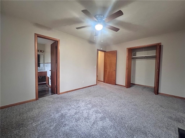 unfurnished bedroom featuring carpet floors, a closet, ceiling fan, and ensuite bathroom