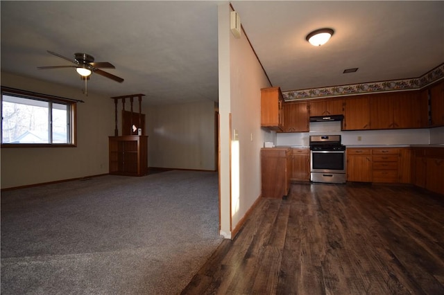 kitchen featuring dark wood-type flooring, ceiling fan, and stainless steel gas stove