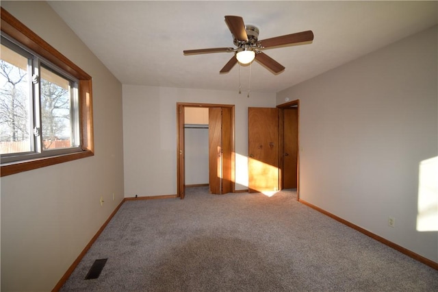 unfurnished bedroom with light carpet, ceiling fan, and a closet