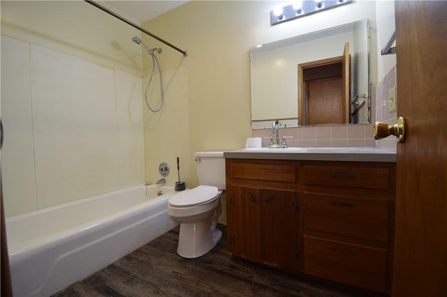 full bathroom with hardwood / wood-style floors, tasteful backsplash, vanity, shower / washtub combination, and toilet