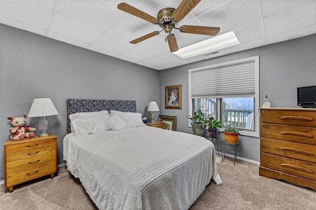 bedroom featuring light carpet and ceiling fan