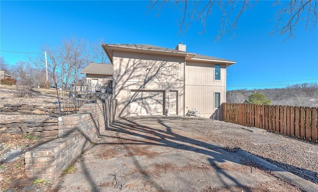 back of house featuring a garage