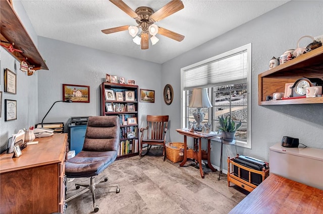 home office featuring ceiling fan and a textured ceiling