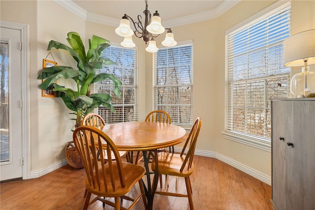 dining room featuring crown molding, hardwood / wood-style flooring, and a notable chandelier