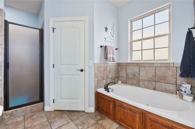 bathroom featuring independent shower and bath