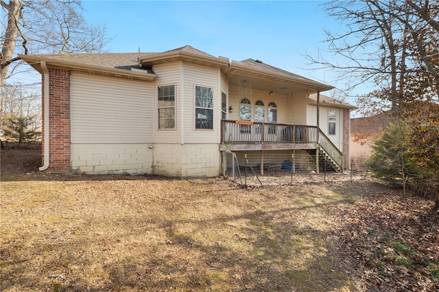 back of house featuring a deck