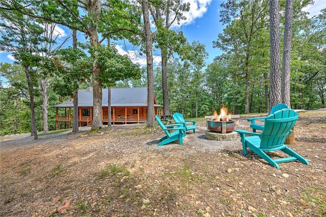 view of yard with a fire pit