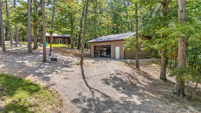 exterior space featuring a garage and an outbuilding