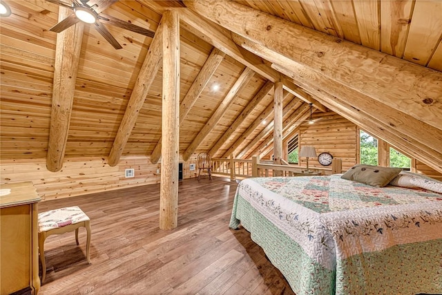 unfurnished bedroom featuring log walls, hardwood / wood-style floors, wood ceiling, ceiling fan, and wood walls