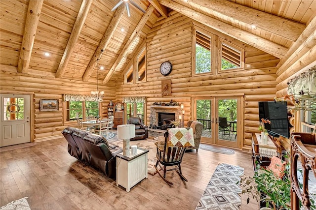 living room featuring wood ceiling, wood-type flooring, beamed ceiling, rustic walls, and high vaulted ceiling