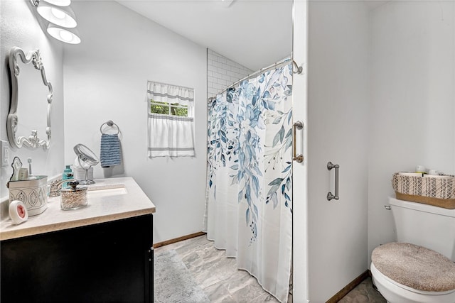 bathroom featuring vanity, toilet, and walk in shower