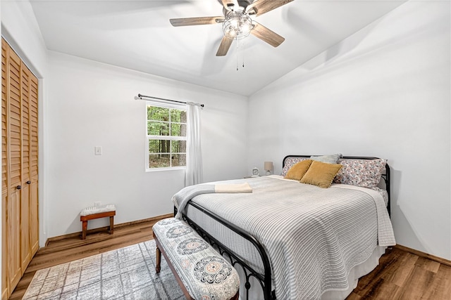 bedroom with wood-type flooring, a closet, and ceiling fan