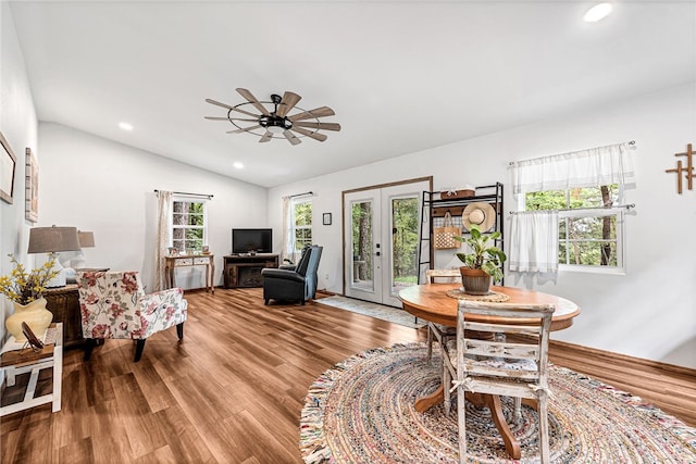 interior space featuring french doors, a wealth of natural light, lofted ceiling, and wood-type flooring