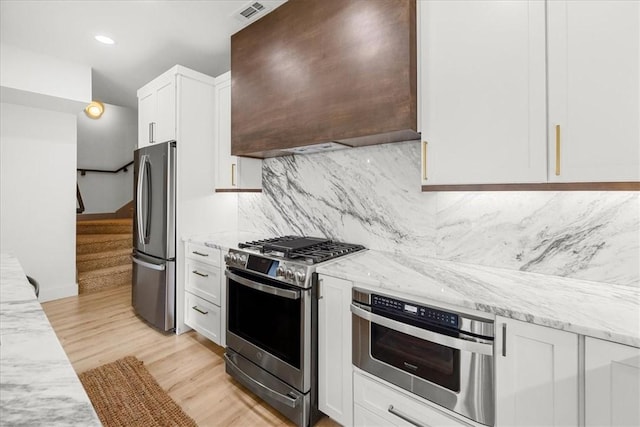 9188 Park Rd, Rogers, AR 72756 - kitchen with decorative backsplash, appliances with stainless steel finishes, light stone counters, white cabinets, and custom exhaust hood