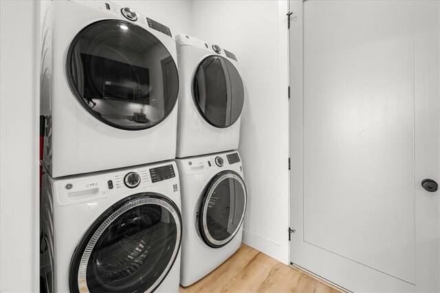 9188 Park Rd, Rogers, AR 72756 - laundry room with stacked washing maching and dryer, laundry area, and light wood-type flooring